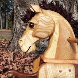 hand carved toddler rocking horse natural wood close up of head