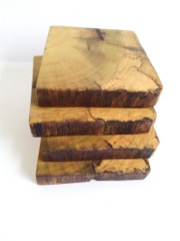 Four wood coasters stacked on top of each other. Wood is spalted poplar
