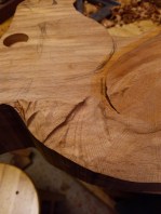 some gouges shown from using power carving chainsaw attachment on angle grinder with beech wood rocking horse neck