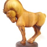 hand carved stylized wood carving of horse on circular walnut stand