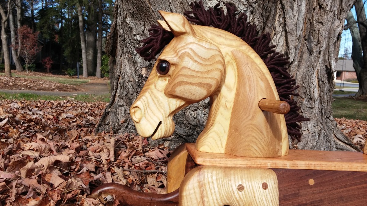 hand carved toddler rocking horse natural wood close up of head