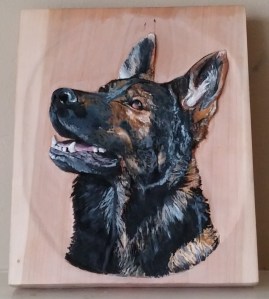 relief carving of german shepherd dog on cherry wood in acrylic paints