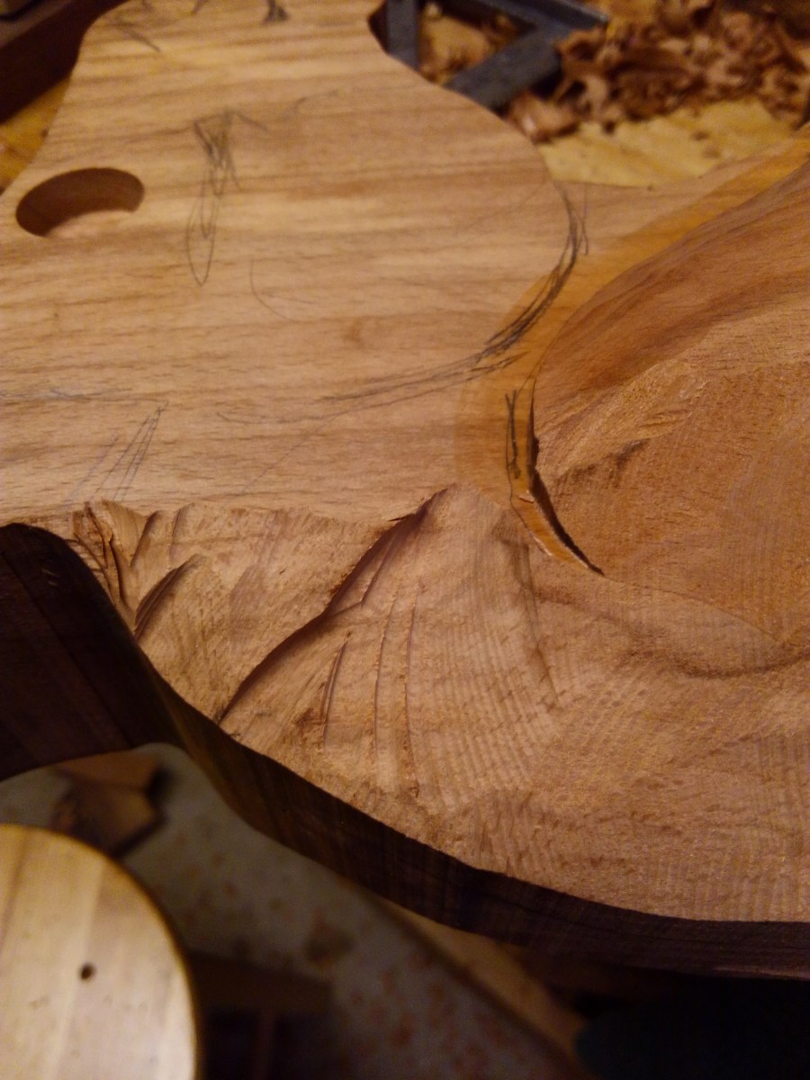 some gouges shown from using power carving chainsaw attachment on angle grinder with beech wood rocking horse neck