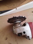 Lancelot chain saw attachment shown on angle grinder with no guard or handle.