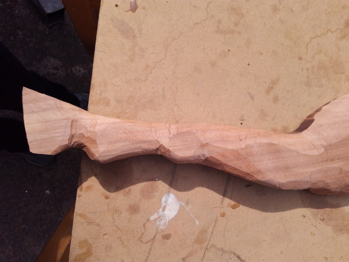 rough carving done on wood carved rocking horse leg, in beech wood, front leg placed on wood work table