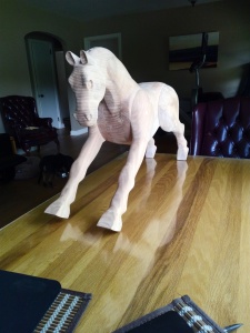 wood rocking horse placed on table, unfinished sanded beech wood