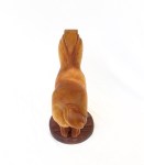 hand carved stylized wood carving of horse on circular walnut stand, view of horse from above