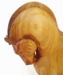 hand carved stylized wood carving of horse on circular walnut stand, close up of horse's neck and head