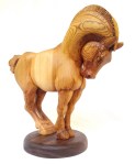 hand carved stylized wood carving of horse on circular walnut stand