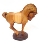 hand carved stylized wood carving of horse on circular walnut stand